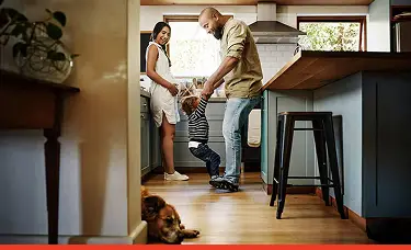 A happy family gathered in a bright kitchen, smiling and enjoying time together