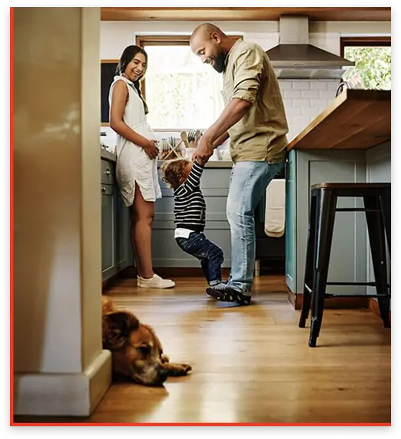 A happy family gathered in a bright kitchen, smiling and enjoying time together